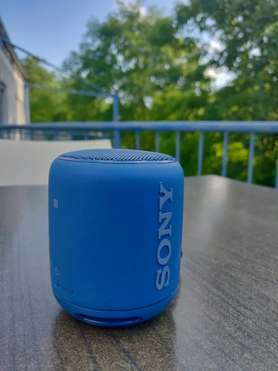 an image of a blue sony sound cube sitting on a table