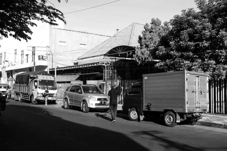 a black and white po shows small trucks parked along a street