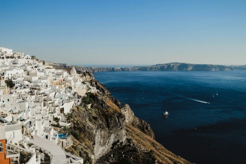 a scenic view of the ocean and a hillside with a boat