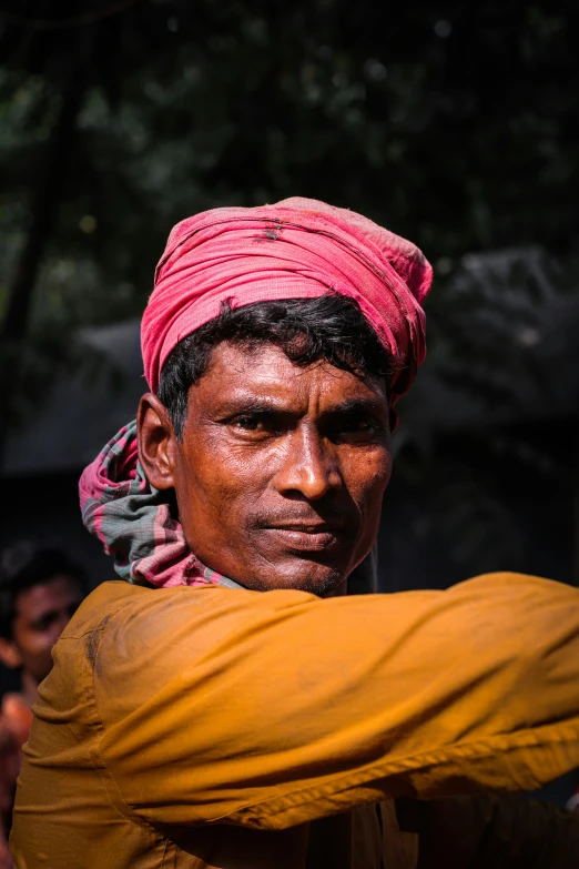 the man is carrying a large bag and smiling