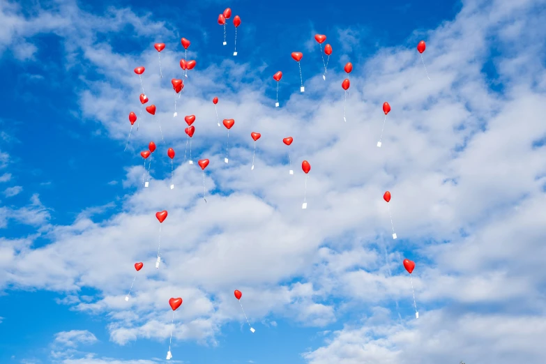 many balloons in the air with people around them