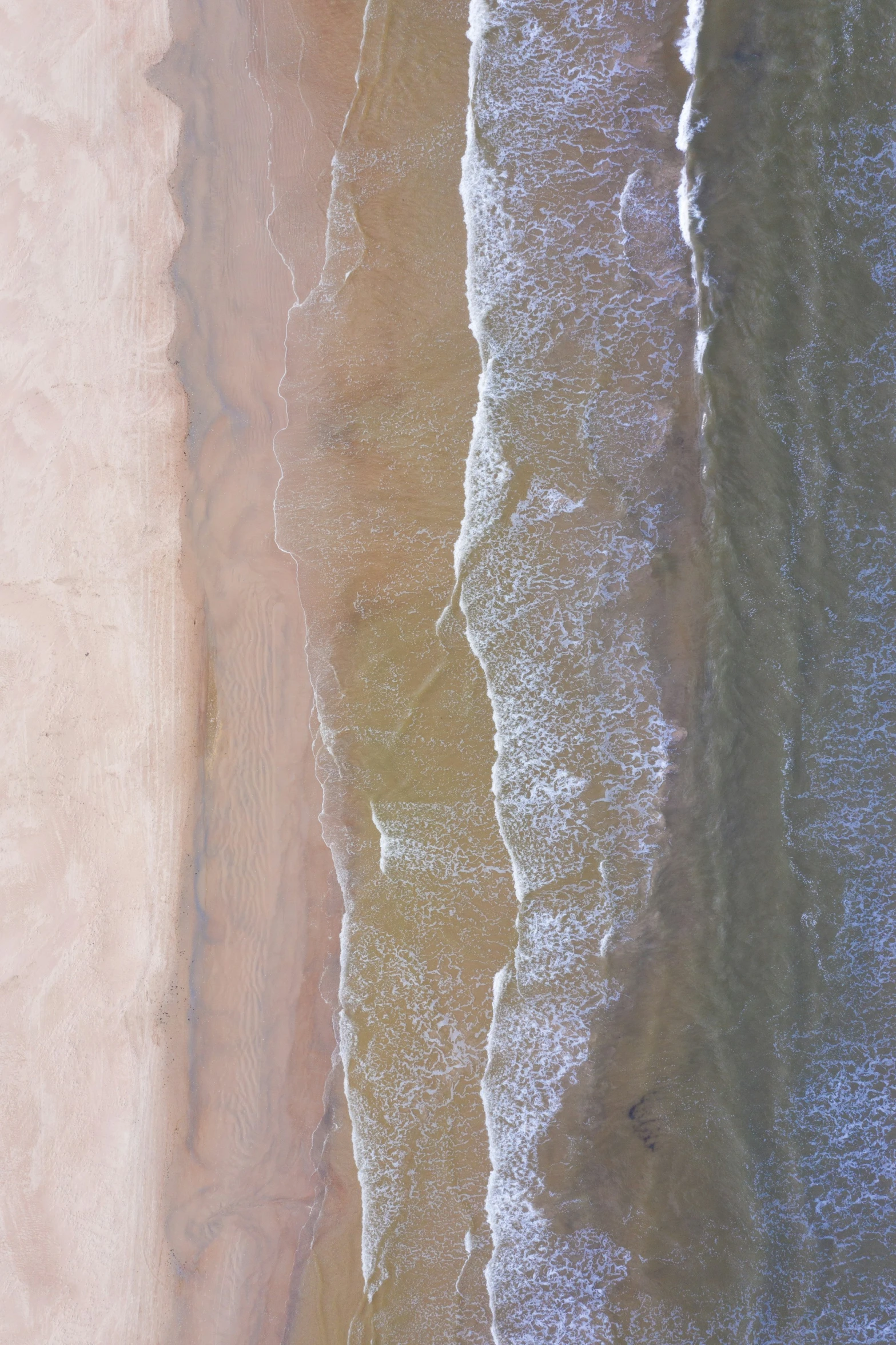 a bird's eye view of the sea and sand