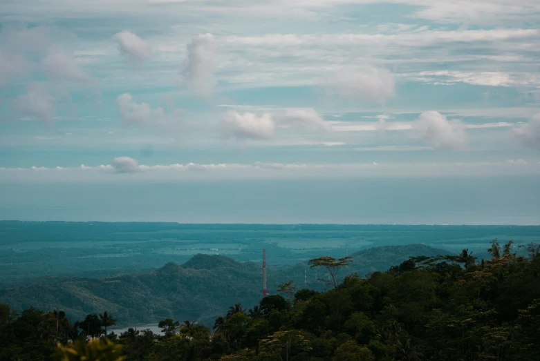 an airplane flying over a mountain landscape on a cloudy day