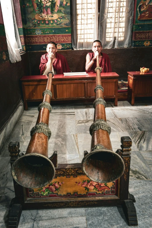 monks on the ground in front of a shrine