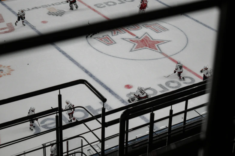 a view through a window of an arena with people playing