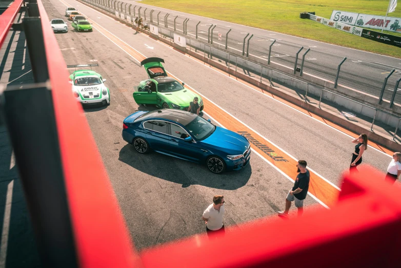 two cars driving down a race track near other cars