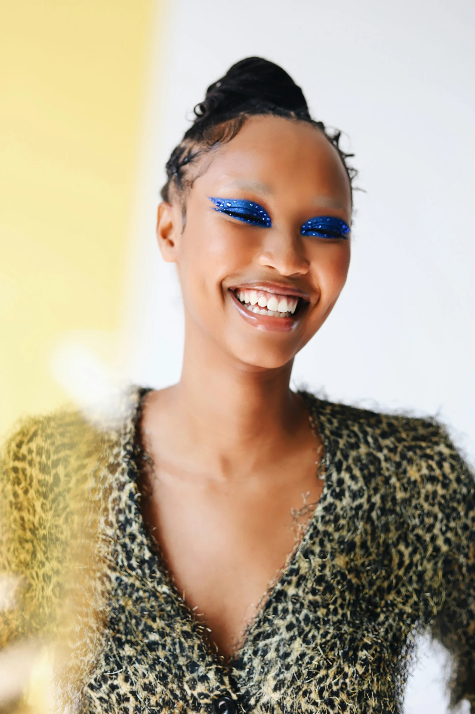 an african american girl with bright blue eyelashes