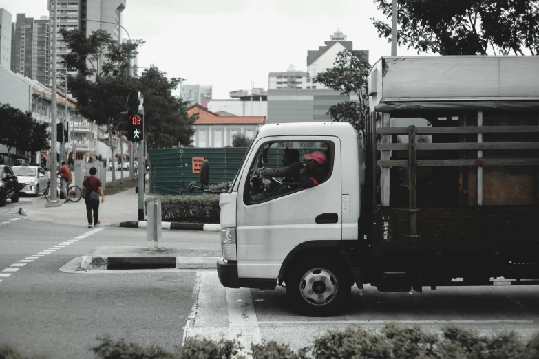 the white truck is on the road waiting for passengers