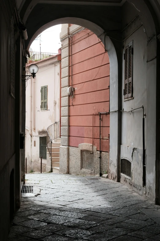 a doorway to a narrow alley between two building