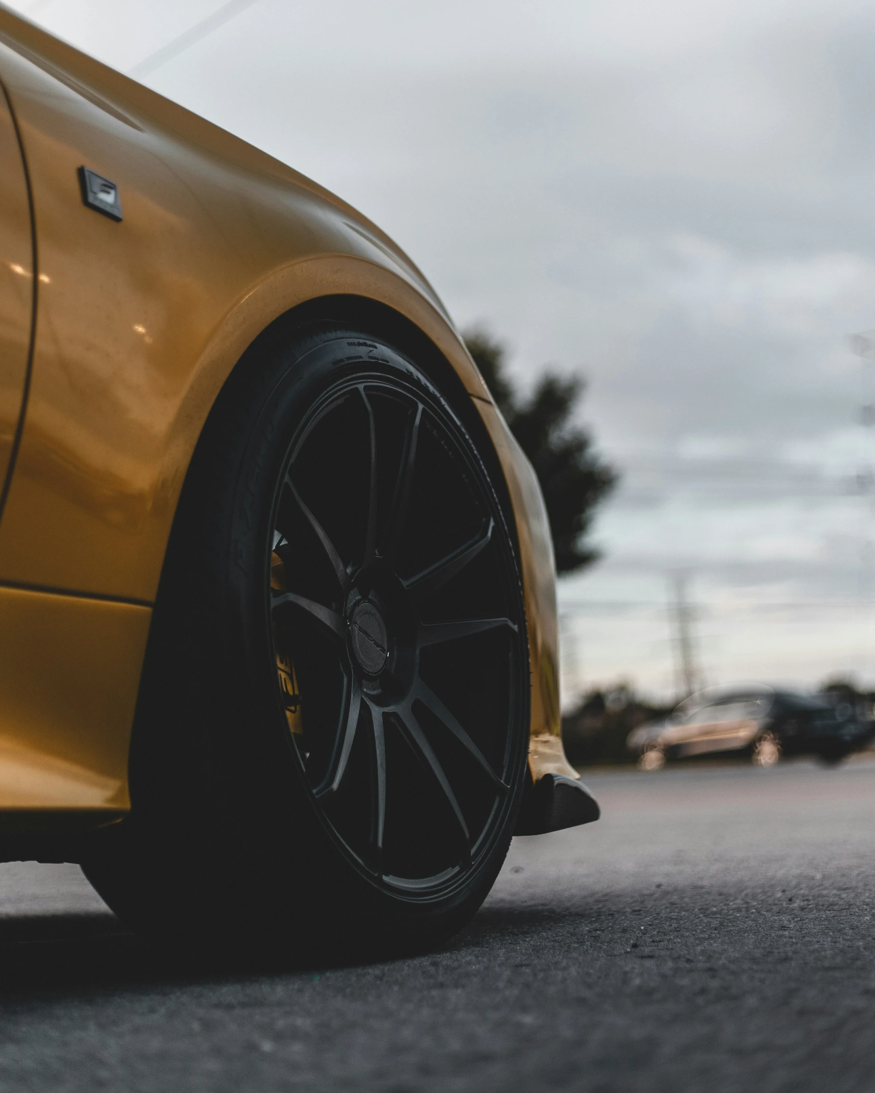 a yellow sports car in a parking lot