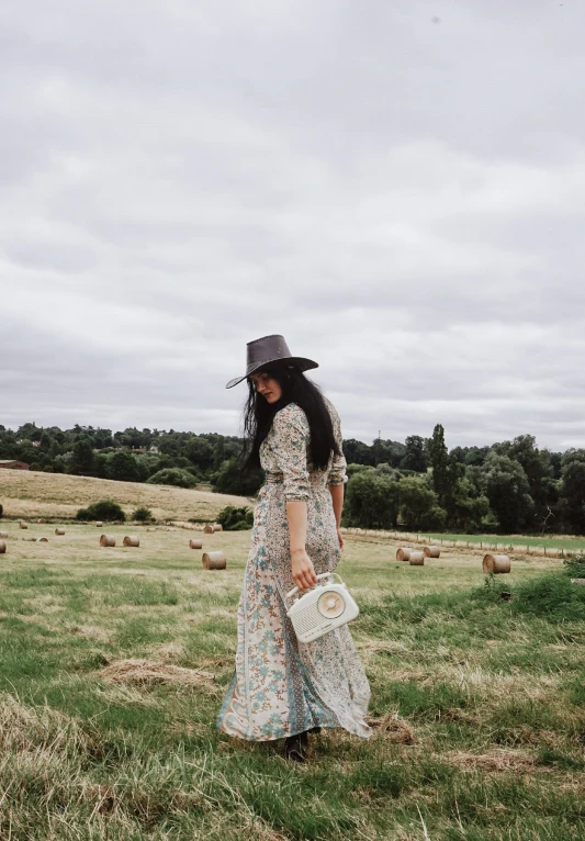 a woman walking across a lush green field