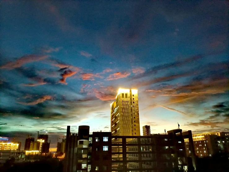 tall buildings against the evening sky with clouds