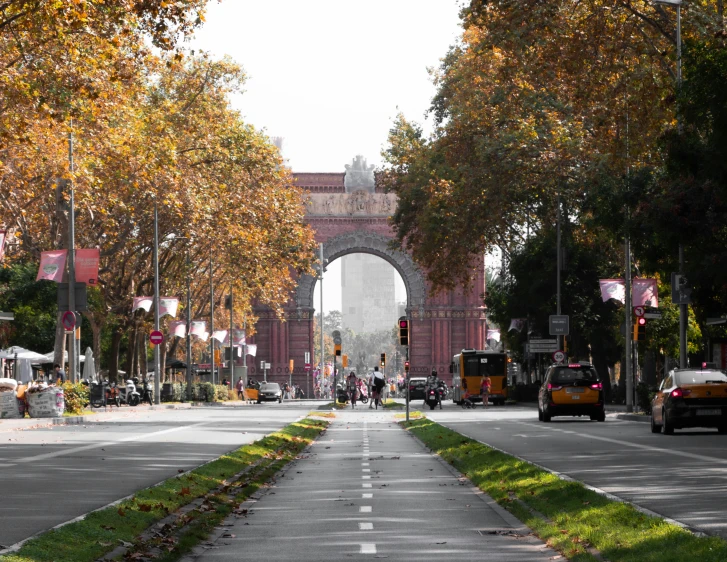 a view of a large archway in the middle of a street