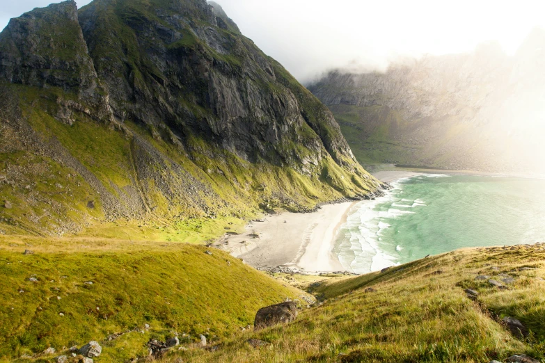 there is a view looking down on the beach and mountains