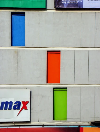 some very colorful windows and a large business sign