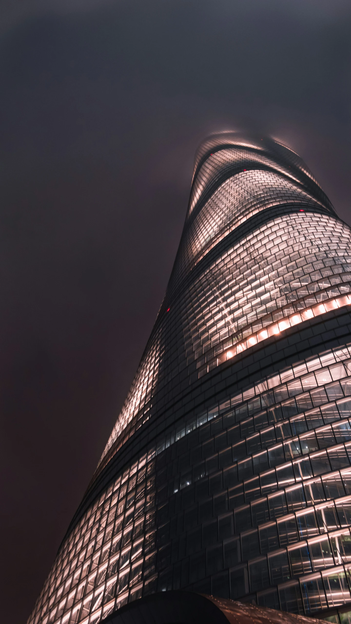 the sky has clouds reflected in this very large building