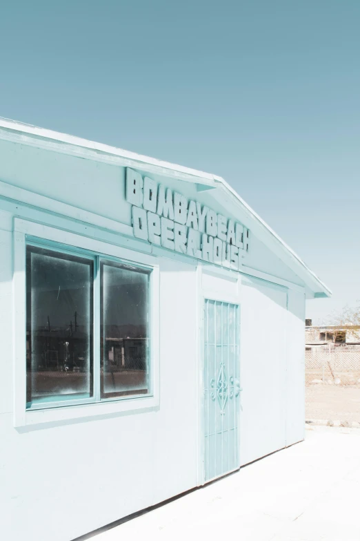 a small white building with windows and a sign that says bob's mexican depot