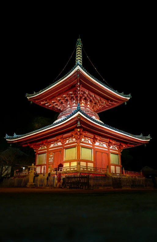 a tall pagoda that is lit up at night