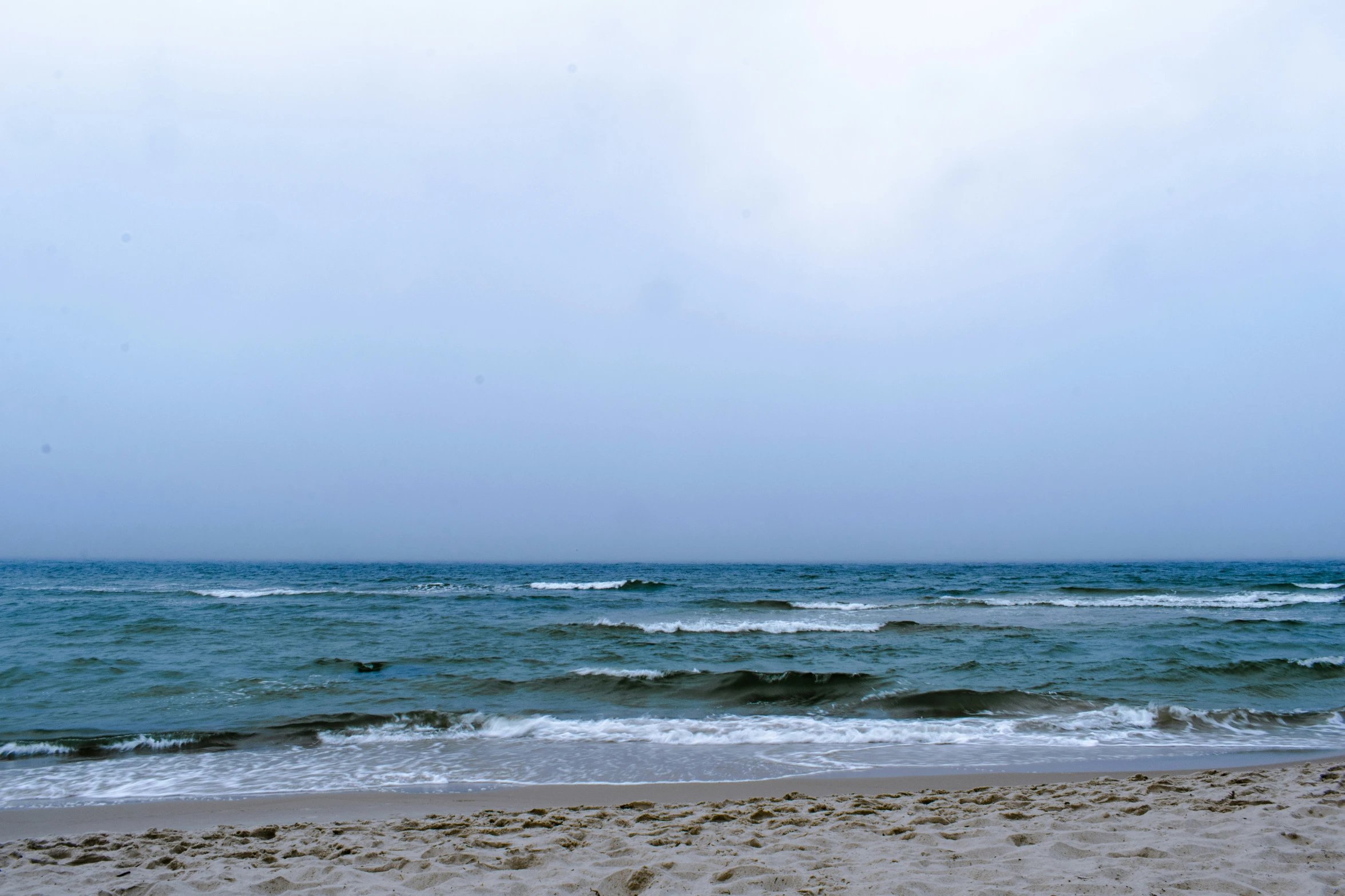 the blue ocean is very cold out on a beach