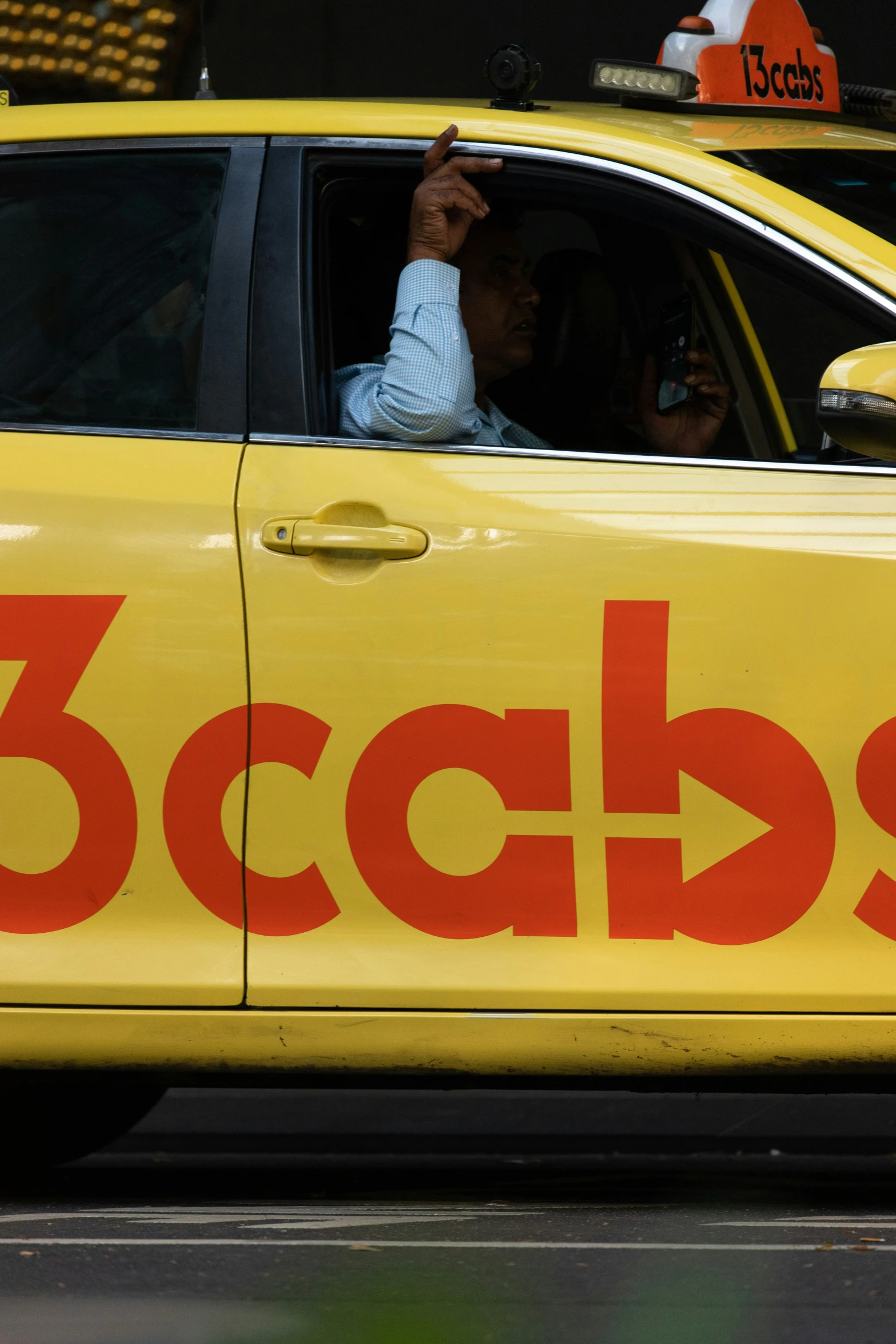 a yellow taxi that reads 5cabs is driving on the street