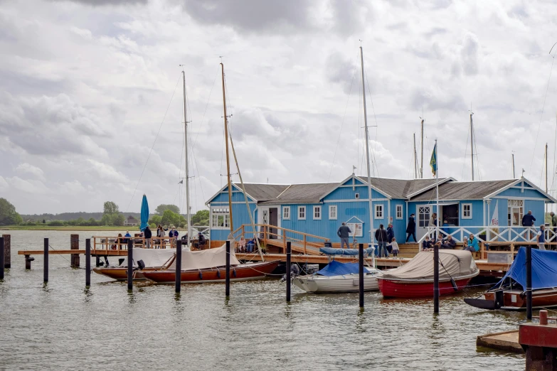 a row of small boats sit in front of the docks on the lake