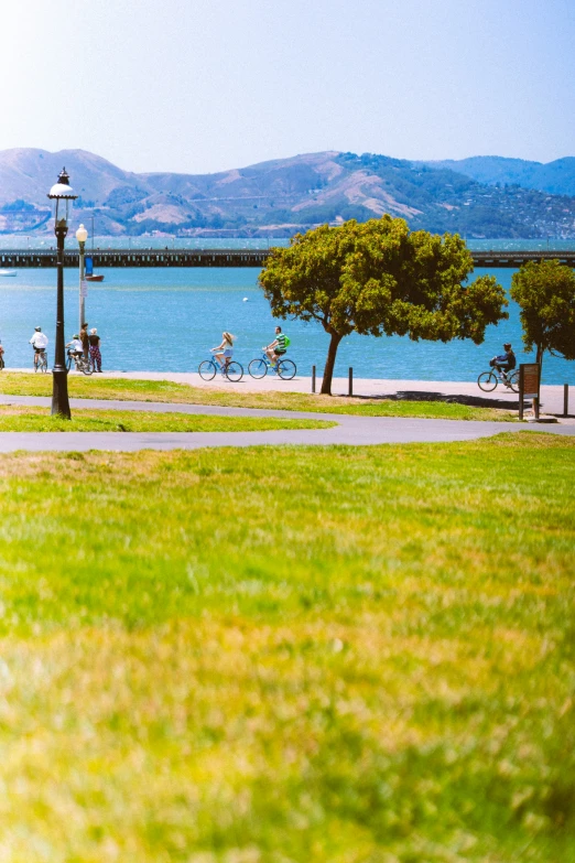 people walking along a sidewalk near the ocean