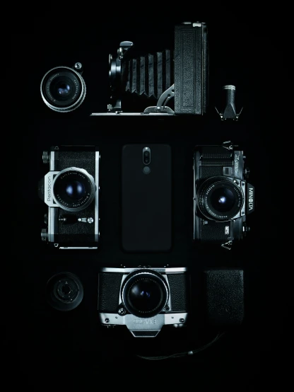 camera, lenses, and other objects lay on a dark background