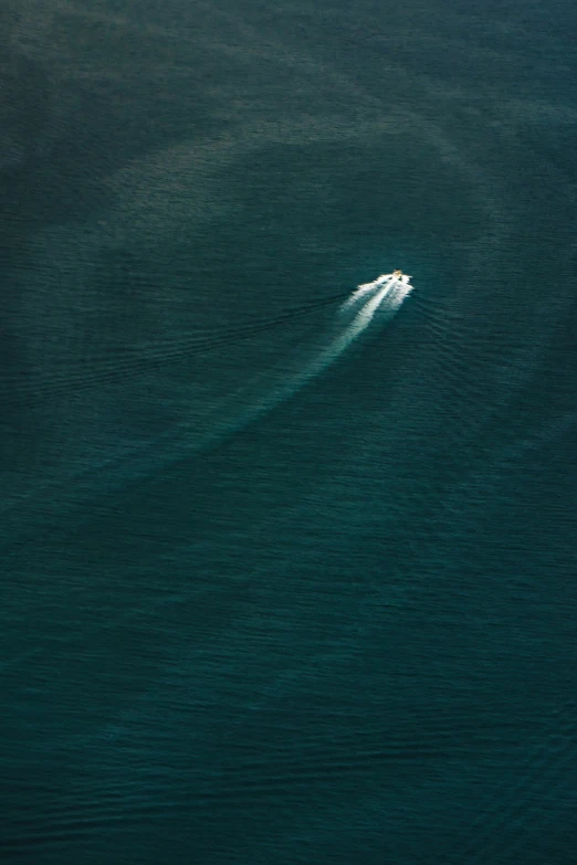 a small boat is seen in the middle of the ocean