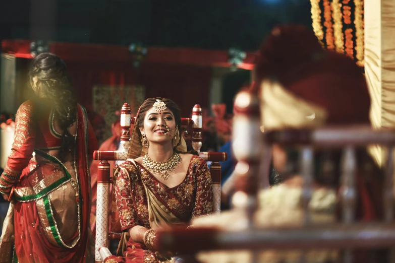 indian woman dressed in traditional saree standing behind a decorated mannequin