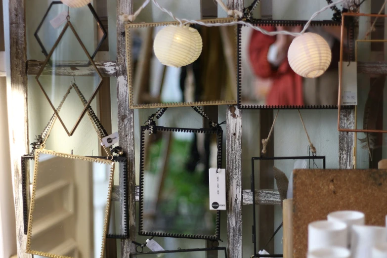 a mirror hanging next to a candle