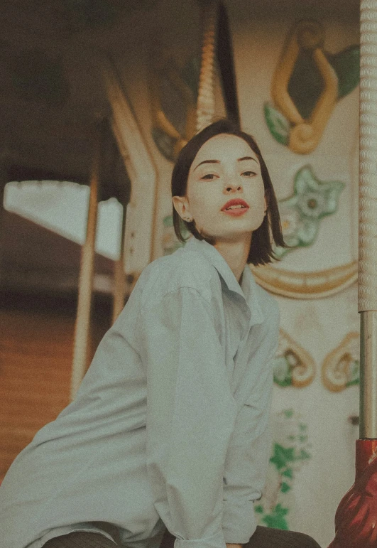 the young lady is posed in her white dress shirt