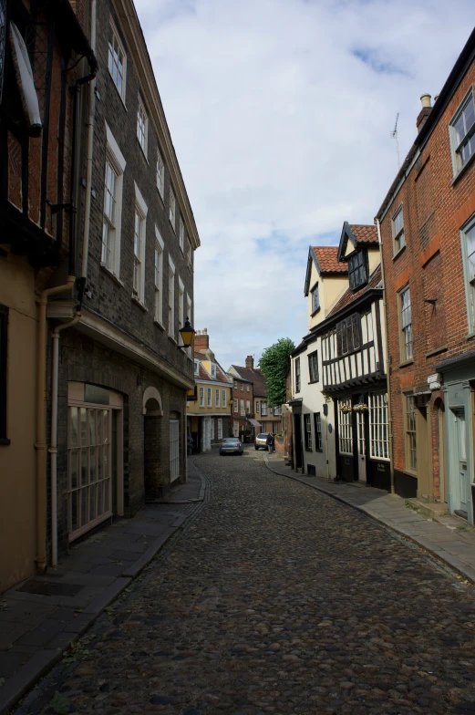 a cobblestone street with buildings on both sides