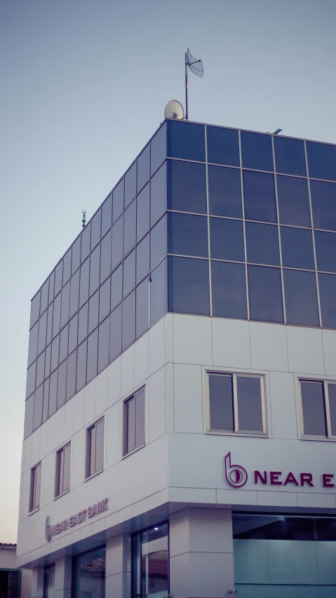 a tall white building with many windows next to it