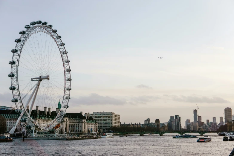 an image of a city with a ferris wheel and boats