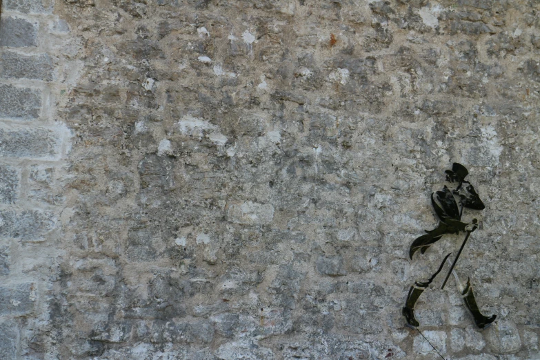 a clock is in front of a ed concrete wall