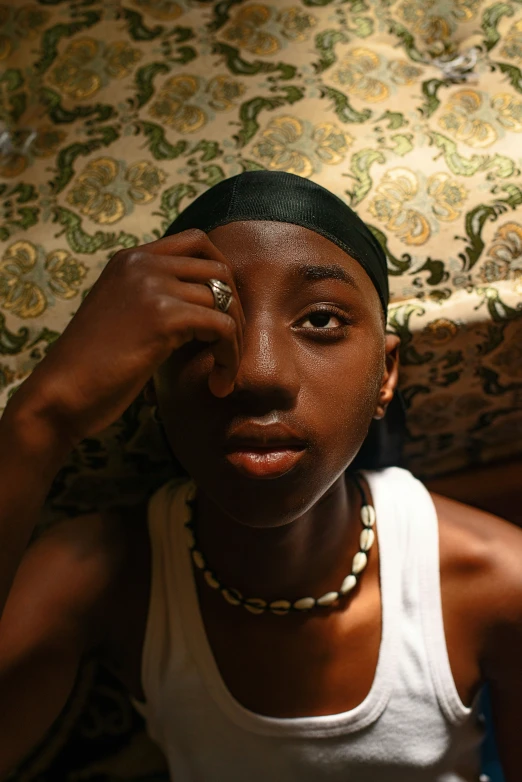 a woman is sitting with her hand on her forehead