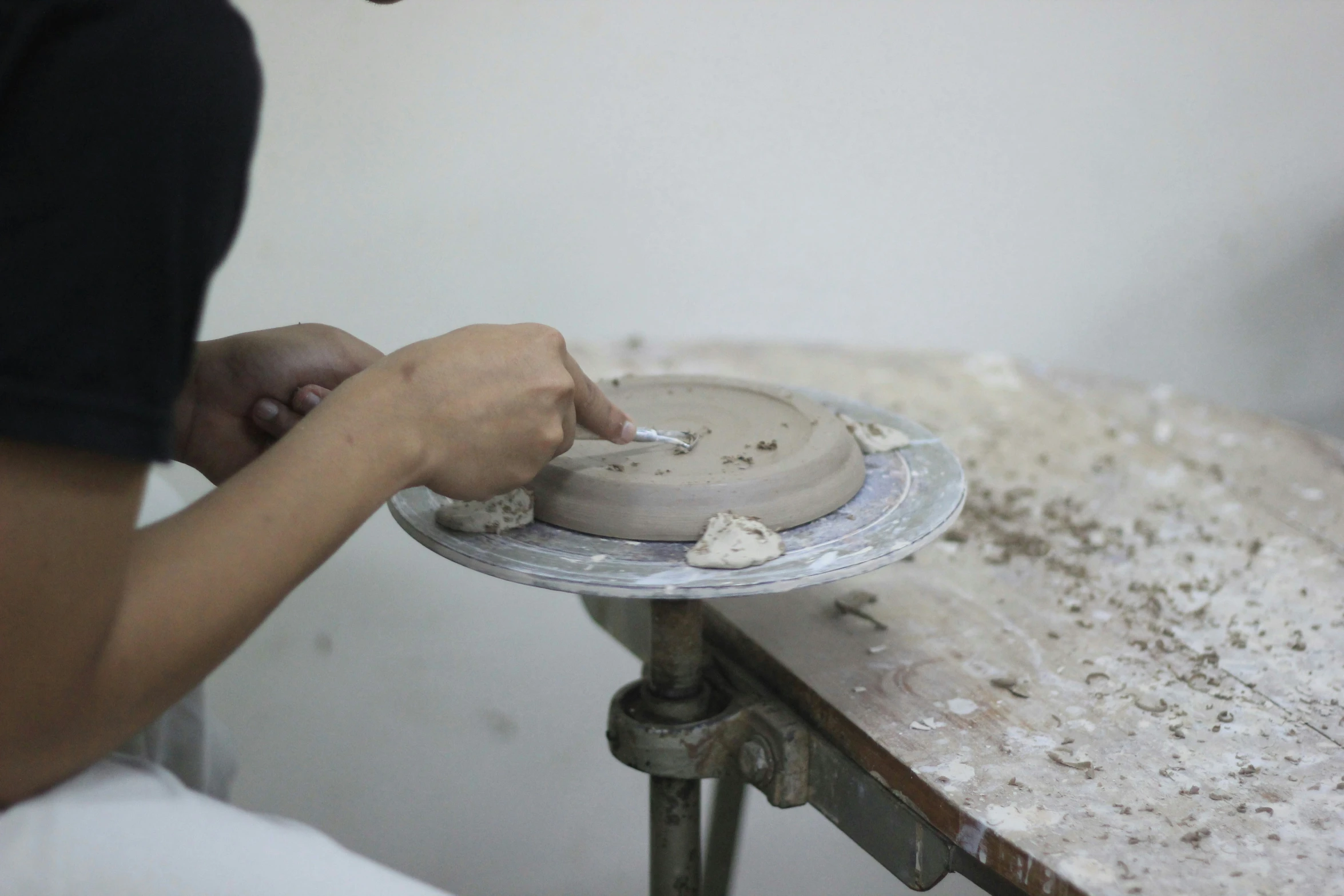 a person placing a cake on a plate