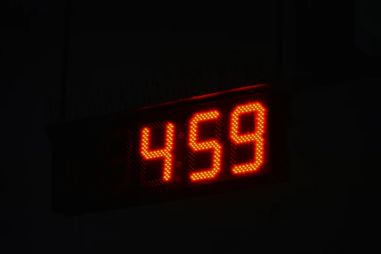 a lit up clock showing the time during the night