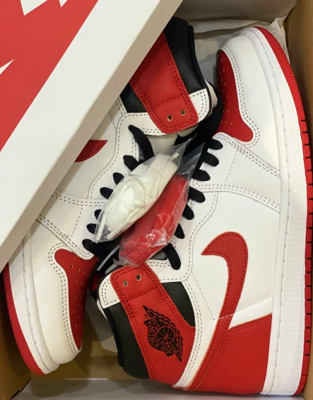 there is a red and black sneaker inside a box