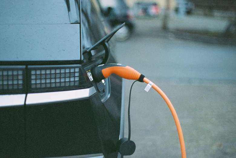 a vehicle with an orange hose hooked to it