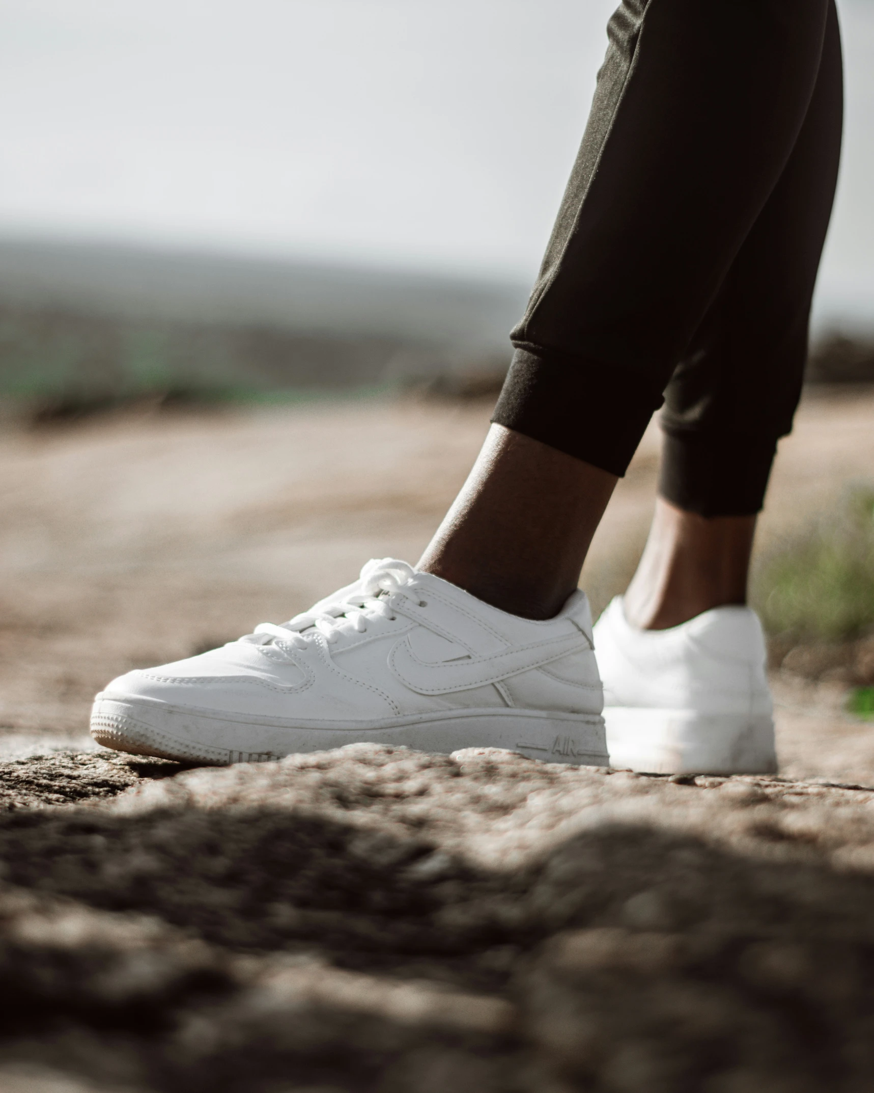 a close up image of a person with white shoes