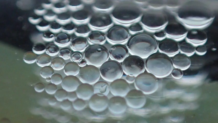 several drops of water floating in a bowl