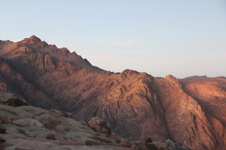 a picture taken from the top of a mountain, with lots of mountains in the background