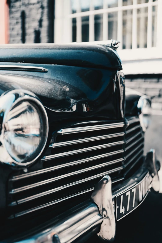 a classic car is parked next to some building