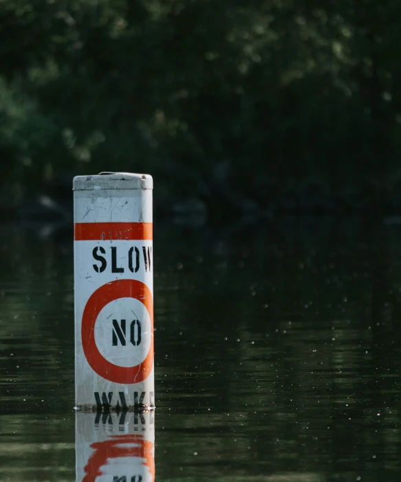 a sign warning of slow access to the river