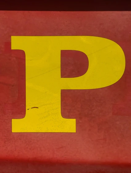 a close up of the letter p on a wall
