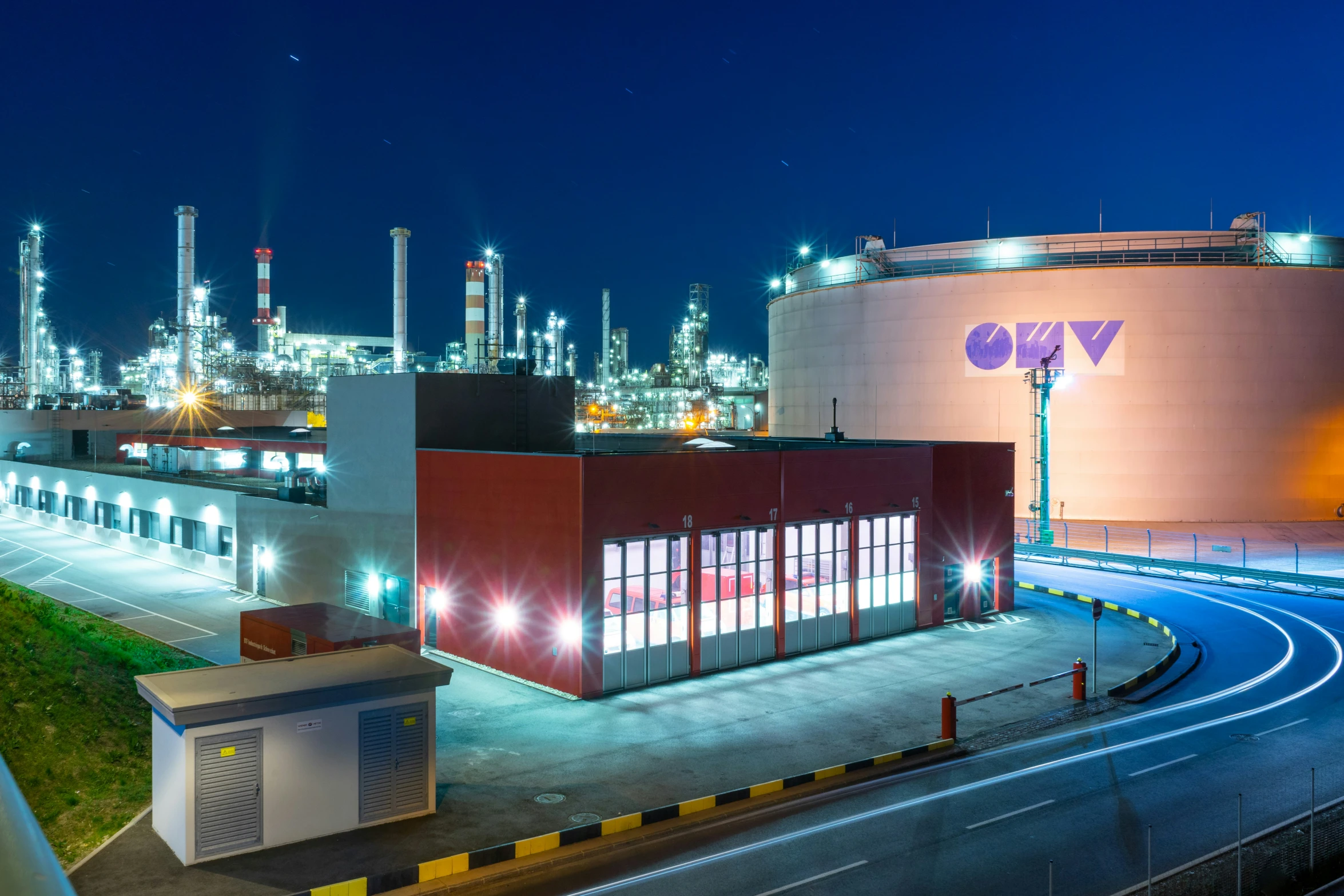 an empty industrial area with an industrial factory at night