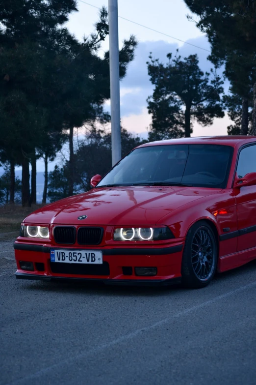 a bright red bmw is parked on the street