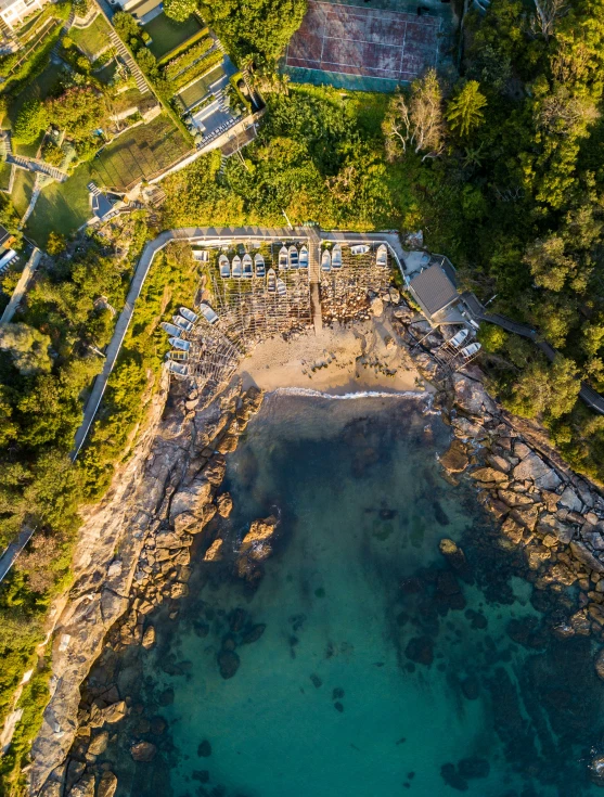 an aerial s of the ocean with two pools and outdoor seating areas