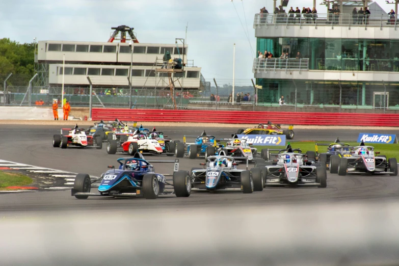 a group of cars driving around a track